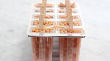 Popsicle mold filled with pork and beans and Vienna sausages