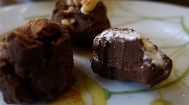 Easy low-carb truffles with three toppings: powdered sweetener, pecans, and cocoa powder.